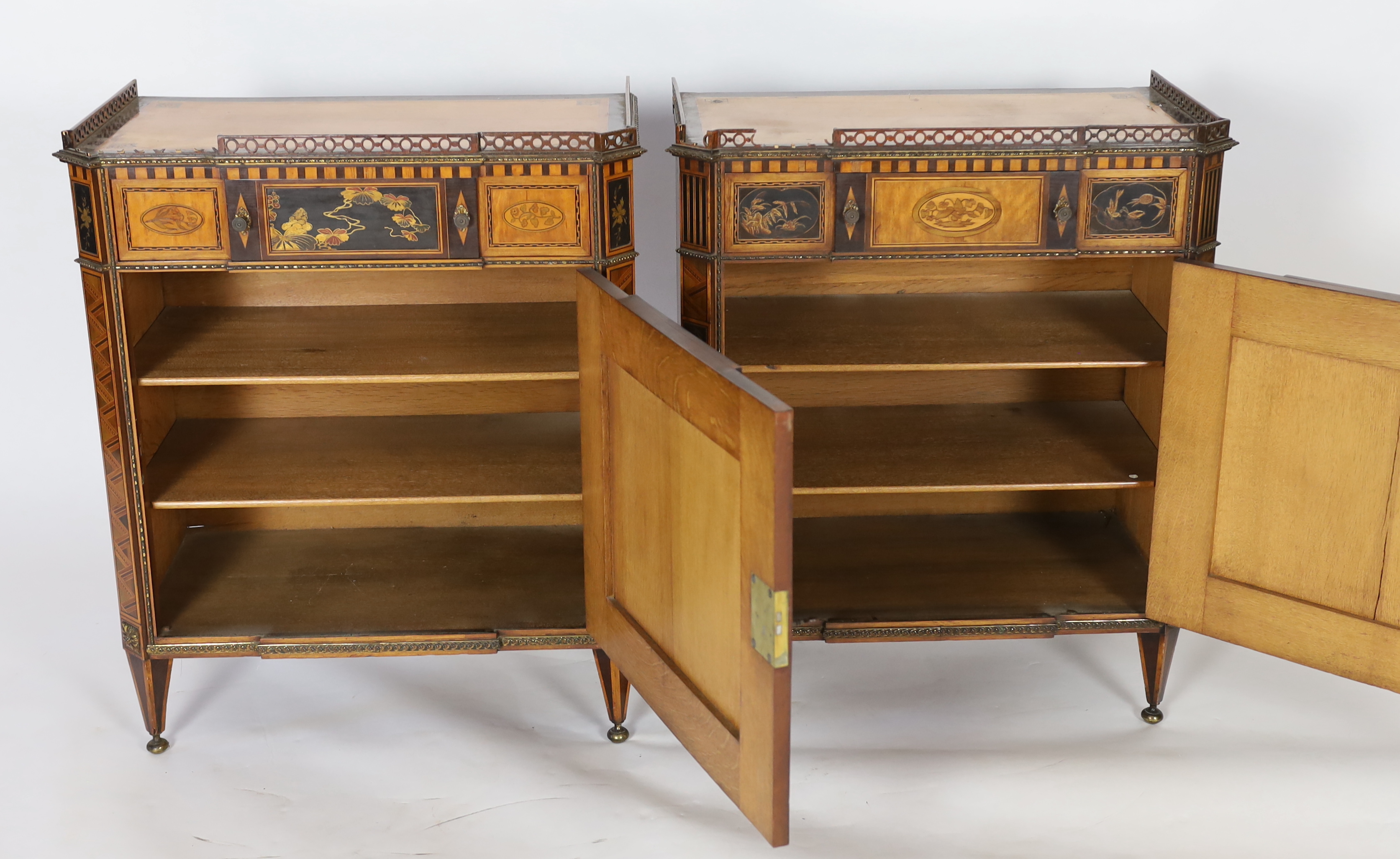 A pair of French Transitional style satinwood and marquetry side cabinets, 57cm wide, 40cm deep, 87cm high